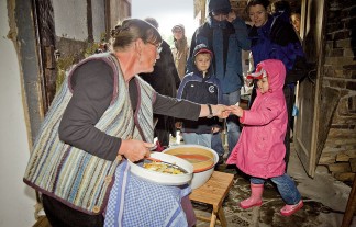 Eine Museumsmitarbeiterin bereitet das Obst für den Dörrofen vor und lässt die Besucher das Obst probieren.